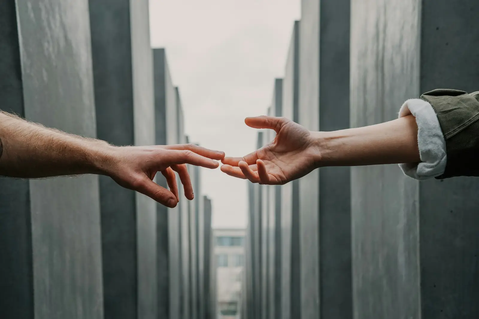 Two hands reaching towards each other