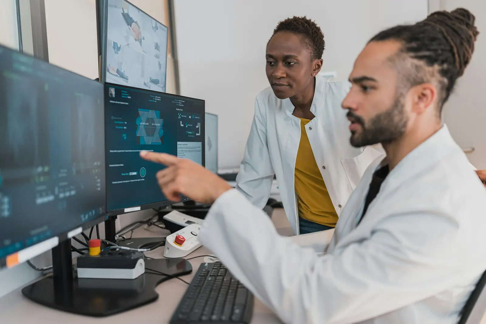 Doctors discussing a case at a workstation